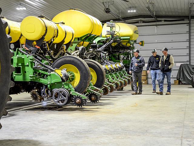 Stuart Sanderson (from left), Mike Henderson and Chad Henderson make final inspections on their planters. (DTN/Progressive Farmer photo by Brent Warren)