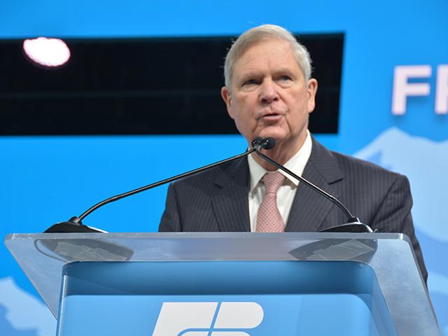 Agriculture Secretary Tom Vilsack speaking earlier this year at the American Farm Bureau Federation annual meeting. The secretary is criticizing the House GOP draft of the farm bill for promising farmers boosts in commodity program through a "budget gimmick" that won't pass Congress. The House Agriculture Committee will markup the bill on Thursday. (DTN photo by Chris Clayton)