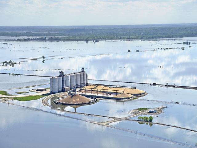 A flooded grain elevator and surrounding farmland along the Missouri River in early spring 2019. A change in crop insurance rules by USDA will eliminate the ability of farmers to buy up higher levels of prevented-planting coverage starting next year. USDA stated the change was made because the higher protection levels only really benefited farmers in North and South Dakota. (DTN file photo by Jim Patrico)