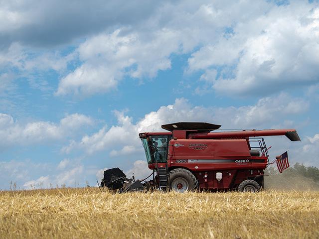 Chris Weaver hangs his American flag on his combine before he harvests barley. The Finksburg, Maryland, farmer who is in DTN's View From the Cab series this season said, "We keep flags displayed everywhere on this farm: on equipment, outside the office and in the farm shop. I'm proud to live and work in this country. And I think it's important to show that pride because it is easy to take it all for granted." (DTN photo by Joel Reichenberger)