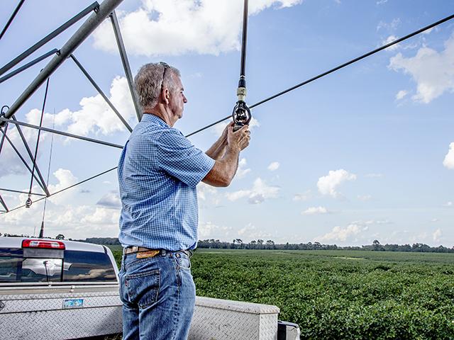 A Georgia farmer retrofits his sprinklers with support of EQIP funding. The Senate farm bill discussion draft reduces EQIP funding between FY2027 and FY2030 before restoring higher baseline funding in FY2031. (Progressive Farmer photo by Mark Wallheiser)