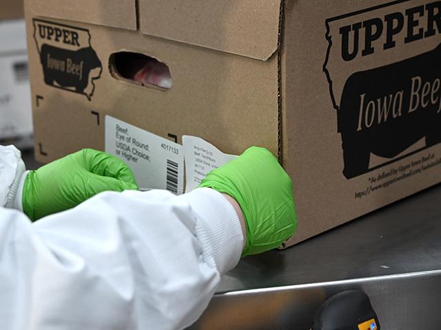 A worker at Upper Iowa Beef puts a label on a beef box, showing what the container holds. (DTN/Progressive Farmer photo by Jennifer Carrico)