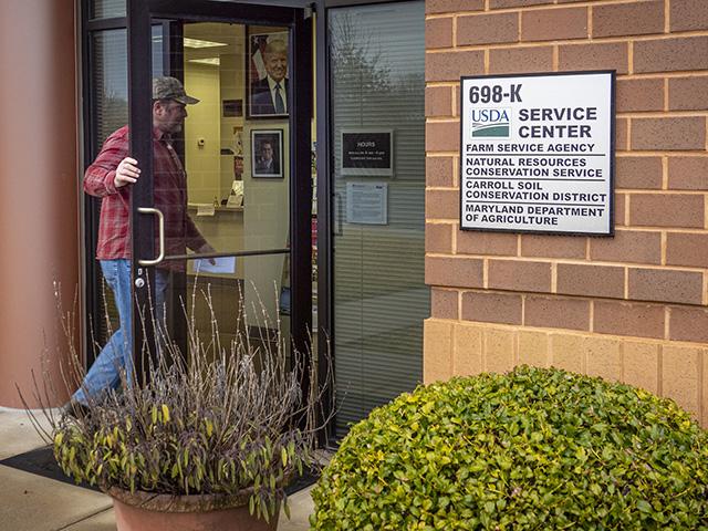 A producer walks into a USDA Service Center. FSA offices remain open on paper, as required by law, but staffing has been shifted and offices fragmented. It's a new model for FSA and NRCS: doing more with less under federal workforce reduction directives, while USDA's reorganization also shifts work and modernizes paperwork. (Photo courtesy of USDA)