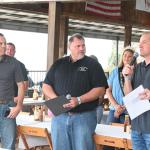 Greene County, Iowa, cattleman Bill Fields, left, and Iowa Cattlemen's Association CEO Bryan Whaley, center, were part of the announcement at the Iowa State Fair on Aug. 18 by Iowa Secretary of Agriculture Mike Naig, right, for a conservation program to convert cropland to pasture and hay ground. (DTN/Progressive Farmer photo by Jennifer Carrico)